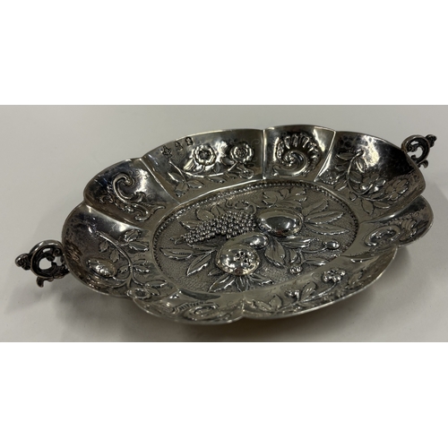 592 - A 19th Century Continental silver wine taster with embossed decoration, marked to interior. Approx. ... 