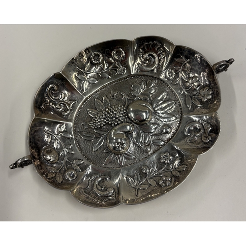 592 - A 19th Century Continental silver wine taster with embossed decoration, marked to interior. Approx. ... 