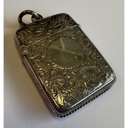 599 - A silver vesta case with engraved decoration. Birmingham 1891. By John Millward Banks. Approx. 18 gr... 