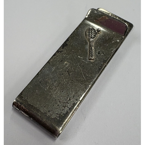 663 - A Sterling silver money clip with applied tennis decoration, marked 925. Approx. 15 grams. Est. £50 ... 