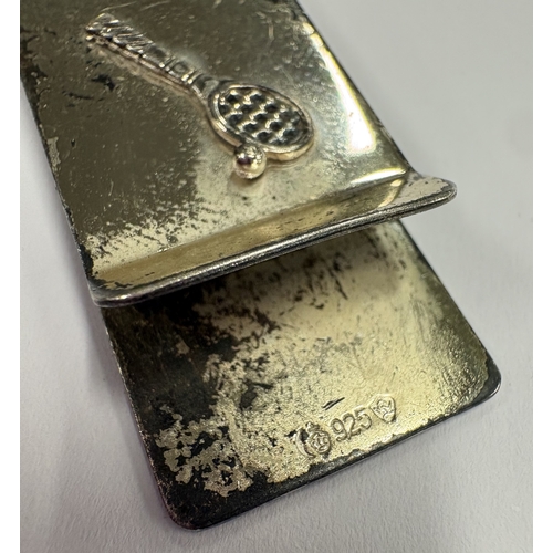 663 - A Sterling silver money clip with applied tennis decoration, marked 925. Approx. 15 grams. Est. £50 ... 