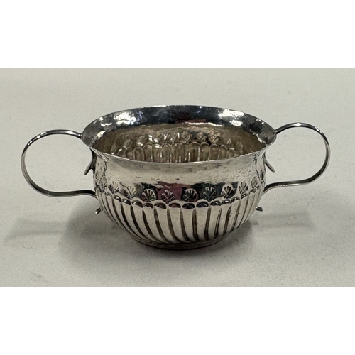 694 - A miniature silver porringer with half-fluted decoration. London, circa 1725. By Louis Laroche. Appr... 