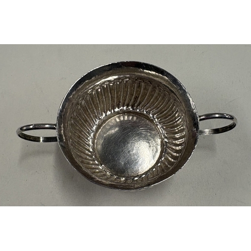 694 - A miniature silver porringer with half-fluted decoration. London, circa 1725. By Louis Laroche. Appr... 