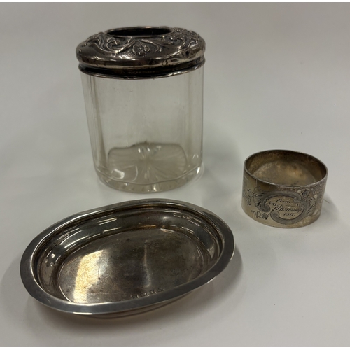 696 - A silver pin dish together with a napkin ring etc. Various dates and makers. Approx. 77 grams. Est. ... 