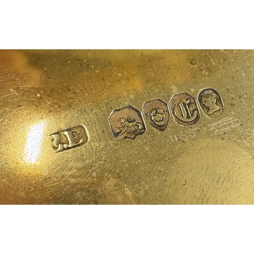 698 - An engine-turned Victorian silver snuff box with chased floral decoration to hinged cover and gilt i... 