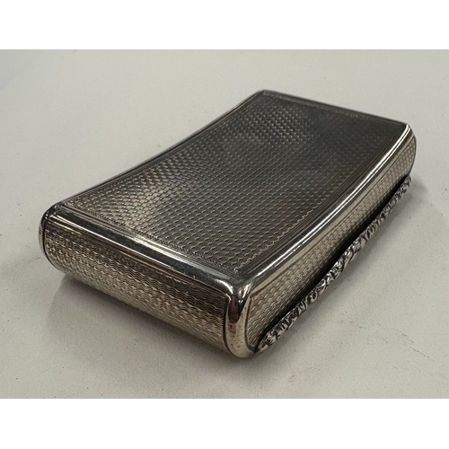 698 - An engine-turned Victorian silver snuff box with chased floral decoration to hinged cover and gilt i... 