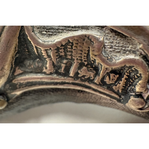 700 - A large heart-shaped silver-mounted mirror profusely decorated with birds and scrolls, with vacant c... 