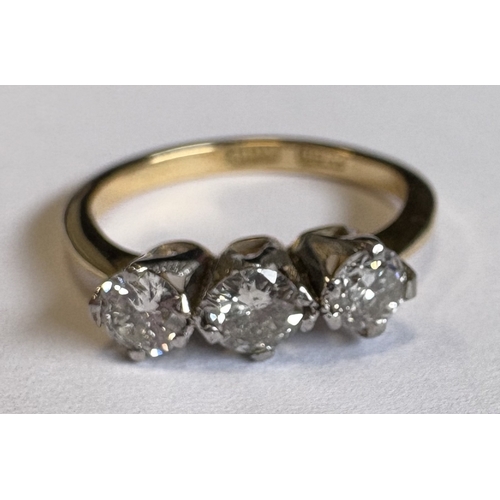 713 - A good three-stone diamond ring in 18 carat gold and platinum claw mount. Approx. 3 grams. Est. £150... 