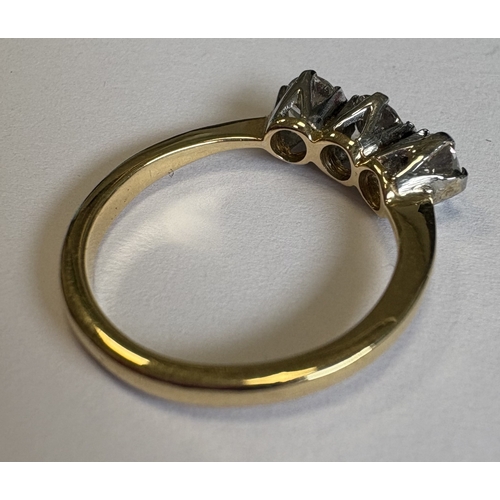 713 - A good three-stone diamond ring in 18 carat gold and platinum claw mount. Approx. 3 grams. Est. £150... 
