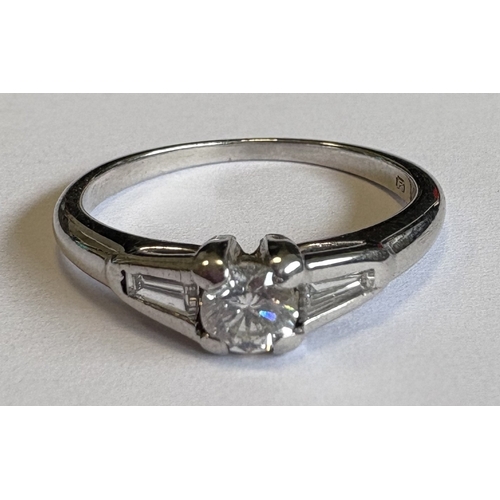 717 - A single-stone diamond ring in 18 carat white gold tapering mount. Approx. 4 grams. Est. £250 - £300... 