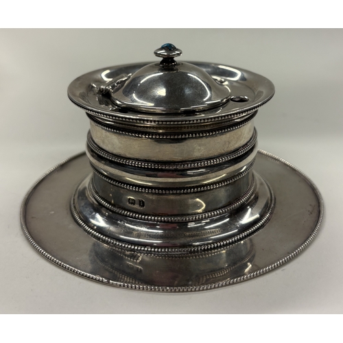 468 - An early 20th Century silver inkwell decorated with a turquoise stone. London 1908. By Liberty & Co.... 