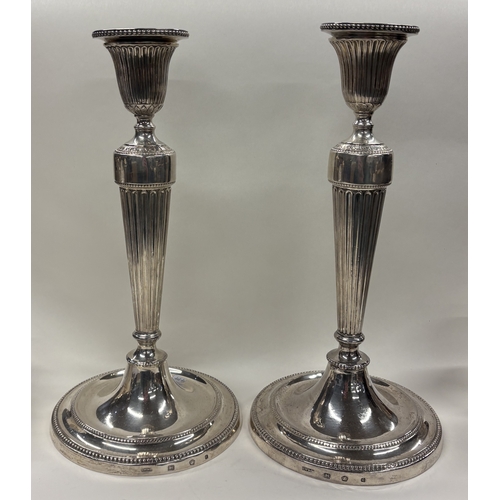 474 - A fine pair of circular 18th Century Georgian cast silver candlesticks with bead decoration. Sheffie... 