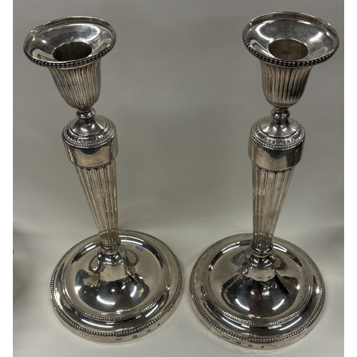 474 - A fine pair of circular 18th Century Georgian cast silver candlesticks with bead decoration. Sheffie... 