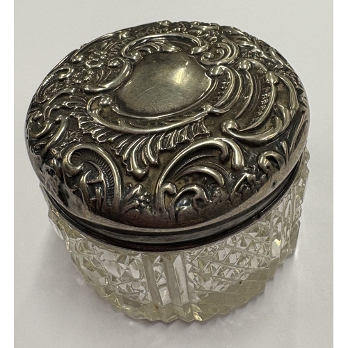 553 - An embossed Victorian silver jewellery box with glass base. Birmingham 1898. Est. £30 - £40.