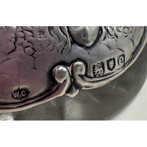 558 - A heavy Victorian silver-mounted glass inkwell chased with cherub decoration. London 1900. By Willia... 