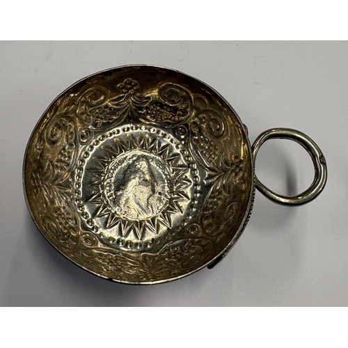 568 - A 19th Century French silver wine taster inset with coin to centre, marked to handle. Approx. 28 gra... 