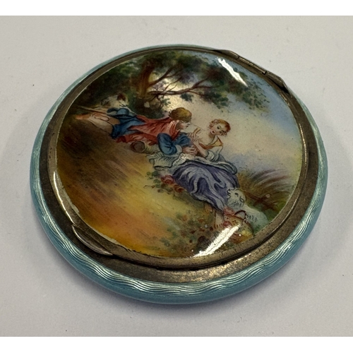 569 - An early 20th Century silver and blue enamelled compact depicting romantic scene to cover. Approx. 5... 