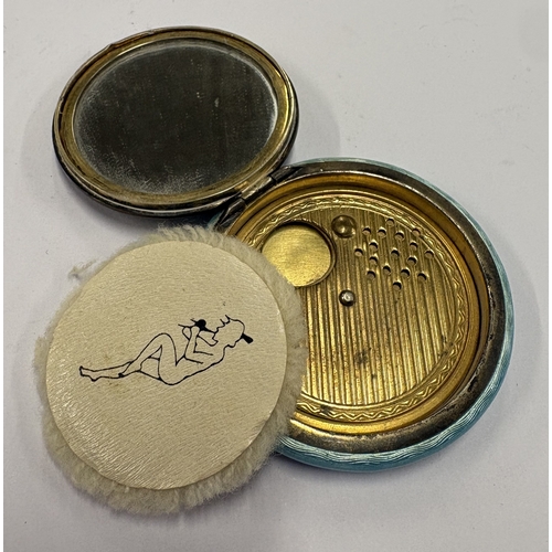 569 - An early 20th Century silver and blue enamelled compact depicting romantic scene to cover. Approx. 5... 
