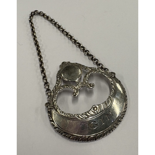 570 - HESTER BATEMAN: A silver decanter label for 'Gin', maker's and lion mark only. Approx. 11 grams. Est... 