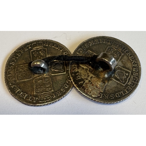 733 - A pair of early silver coins mounted as buttons. Approx. 14 grams. Est. £20 - £30.