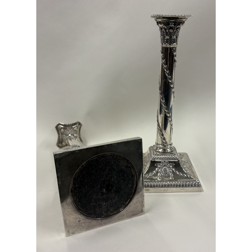 691 - A good pair of silver candlesticks on square bases with gadroon rims. Sheffield 1893. By Hawksworth,... 