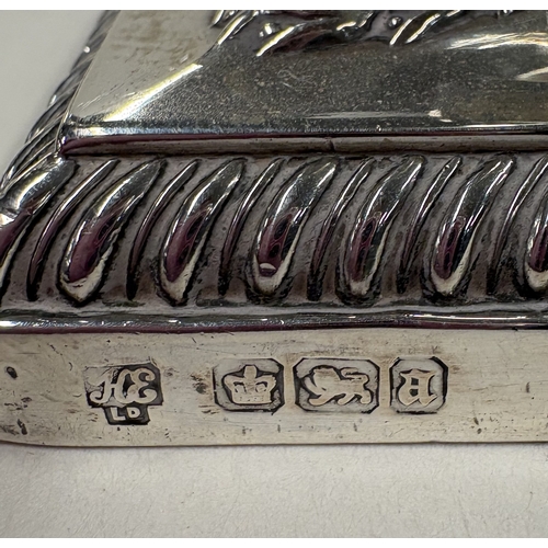 691 - A good pair of silver candlesticks on square bases with gadroon rims. Sheffield 1893. By Hawksworth,... 