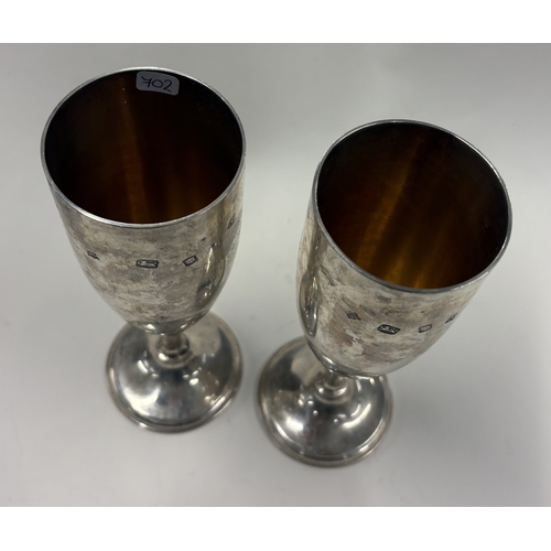 702 - A large pair of tapering silver champagne flutes with gilt interiors. London 1973. By John Henry Ode... 
