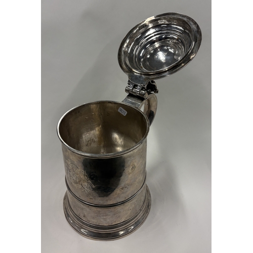 703 - A plain Georgian silver domed-top tankard on reeded base, marked to lid, handle and body. London 173... 
