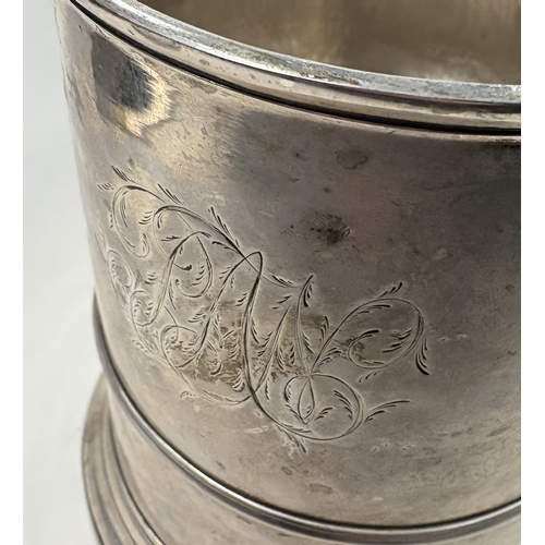 703 - A plain Georgian silver domed-top tankard on reeded base, marked to lid, handle and body. London 173... 