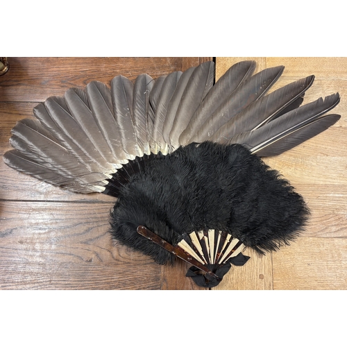 307 - An unusual feather fan with tortoiseshell body together with another similar. Est. £20 - £30.