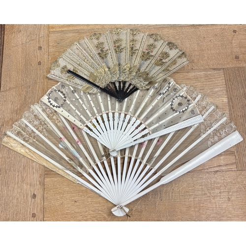 309 - An attractive gilded lace fan together with two others. Est. £20 - £30.