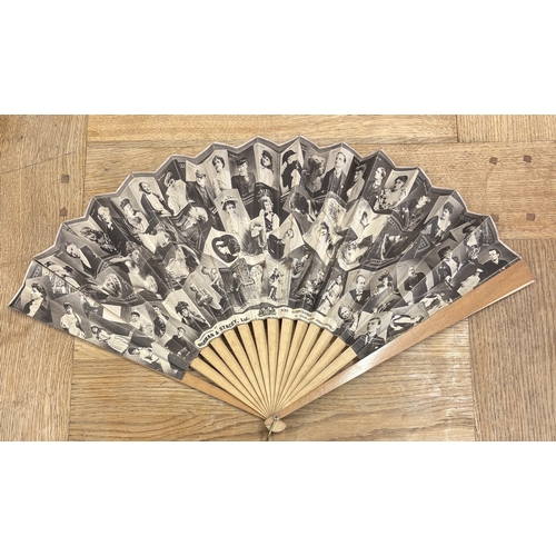 312 - A retro treen and paper fan decorated with a Norman and Stacey Ltd advertising feature of 20th Centu... 