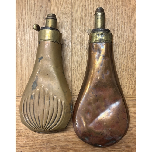 313 - A copper and brass shot flask decorated with dogs together with one other. Est. £20 - £30.