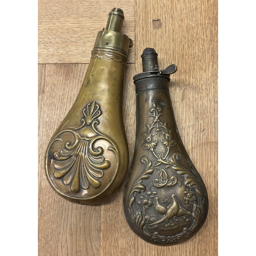 315 - A copper and brass shot flask decorated with pheasants together with one other. Est. £20 - £30.