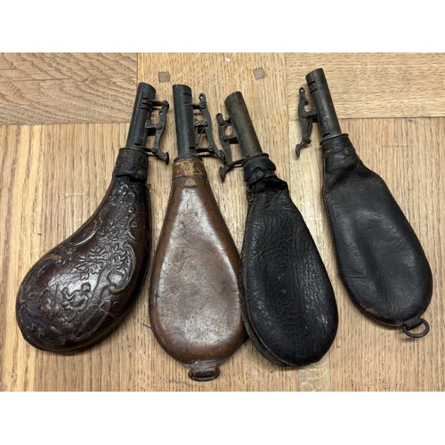 316 - Four leather shot flasks. Est. £20 - £30.