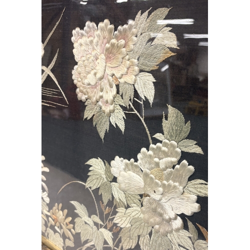 462 - A decorative framed and glazed silk picture depicting flowers. Approx. 68 cms x 55 cms (ss). Est. £2... 