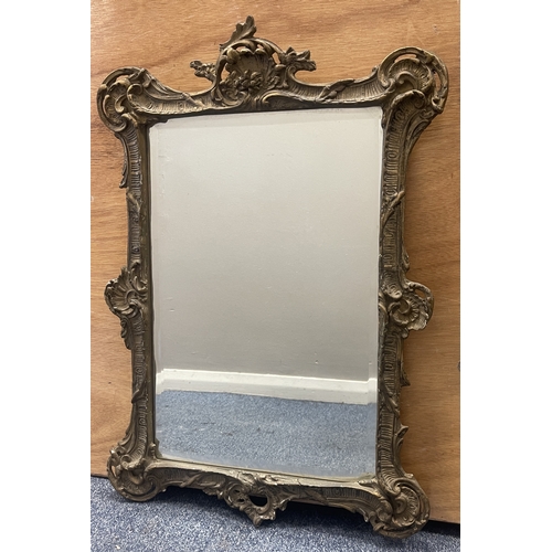 348 - An old gilded framed mirror. Approx. 42 cms x 62 cms. Est. £30 - £40.