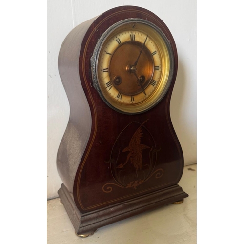 332 - A mahogany shaped mantle clock with brass face and inlaid decoration. Est. £20 - £30.