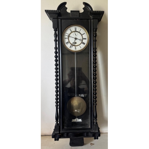 331 - An ebony cased wall clock with white painted dial. Est. £30 - £50.