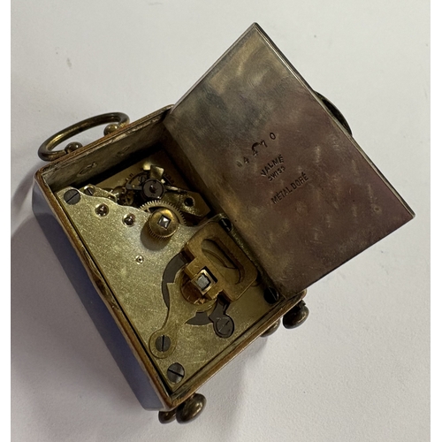 47 - An early 20th Century metal and enamelled clock in case. Est. £500 - £800.