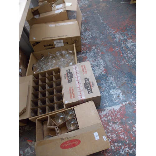 123 - EIGHT BOXES OF NEW PUB GLASSES TO INCLUDE MAGNERS, FOSTERS, THATCHERS ETC