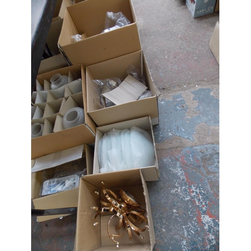 128 - TEN BOXES OF NEW LIGHT FITTINGS - WALL LIGHTS, GLASS SHADES, GRASS EFFECT ETC