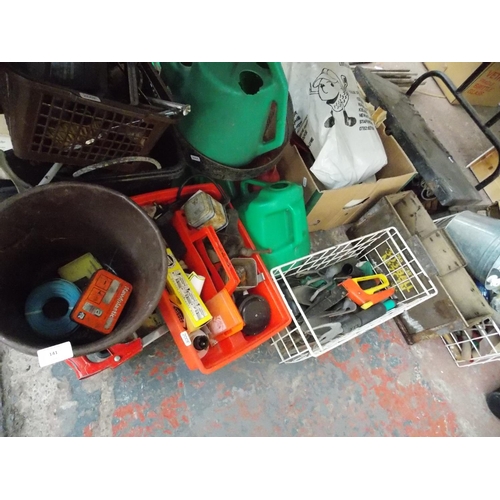 141 - A LARGE MIXED LOT OF NINE BOXES CONTAINING PETROL CANS, GARDENING TOOLS, SMALL CAST IRON BENCH VICE ... 