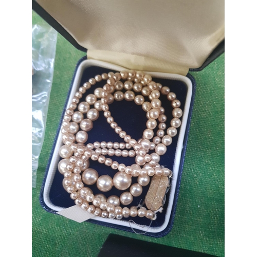 336 - A BOX OF FAUX PEARLS AND A GOLD COLOURED CHAIN