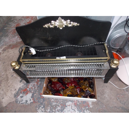 146 - A LARGE BLACK AND BRASS EFFECT ELECTRIC FIRE WITH GLASS COALS