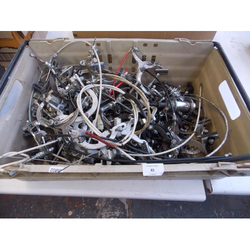 83 - A BOX CONTAINING A LARGE QUANTITY OF BICYCLE SPARES TO INCLUDE BRAKE SETS, HUBS ETC