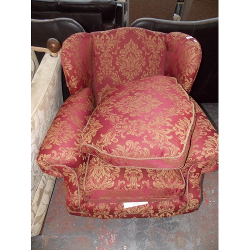 484 - A RED FLORAL PATTERNED TWO SEATER SOFA WITH TWO MATCHING CHAIRS AND A FOOT STOOL