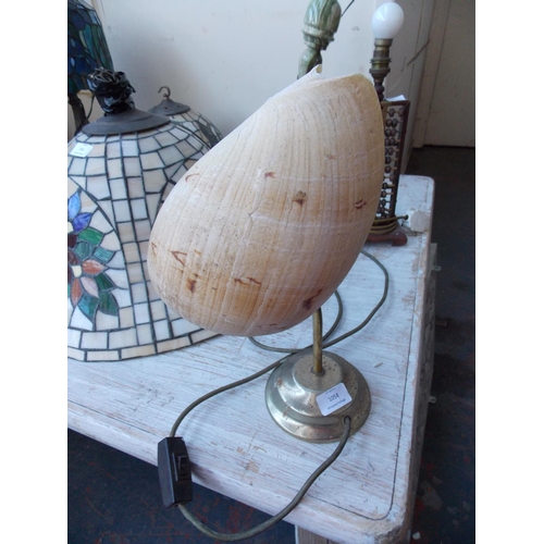 1058 - AN UNUSUAL BRASS LAMP WITH MELO AETHIOPICA SHELL SHADE