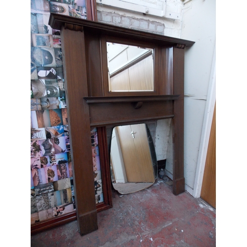 1267 - A TALL MAHOGANY FIRE SURROUND WITH BEVEL EDGED MIRROR TOP