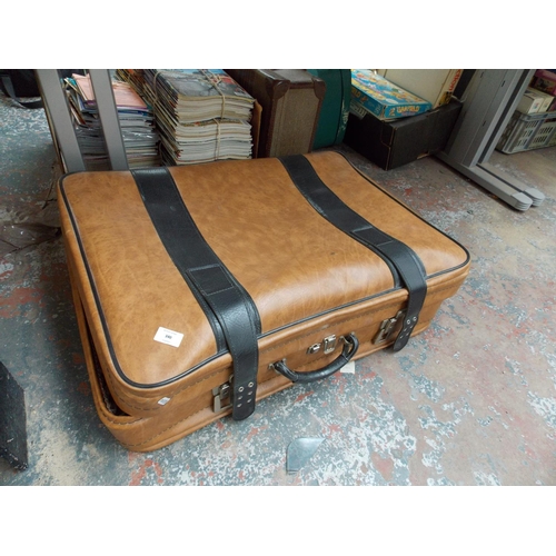 269 - THREE GRADUATED LEATHERETTE SUITCASES